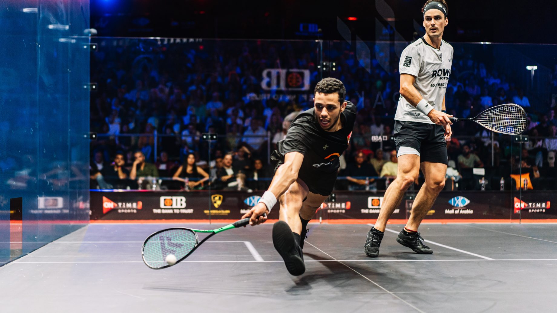 Mostafa Asal (left) takes on Paul Coll (right) during the men's 2022-23 CIB PSA World Tour Finals title decider.