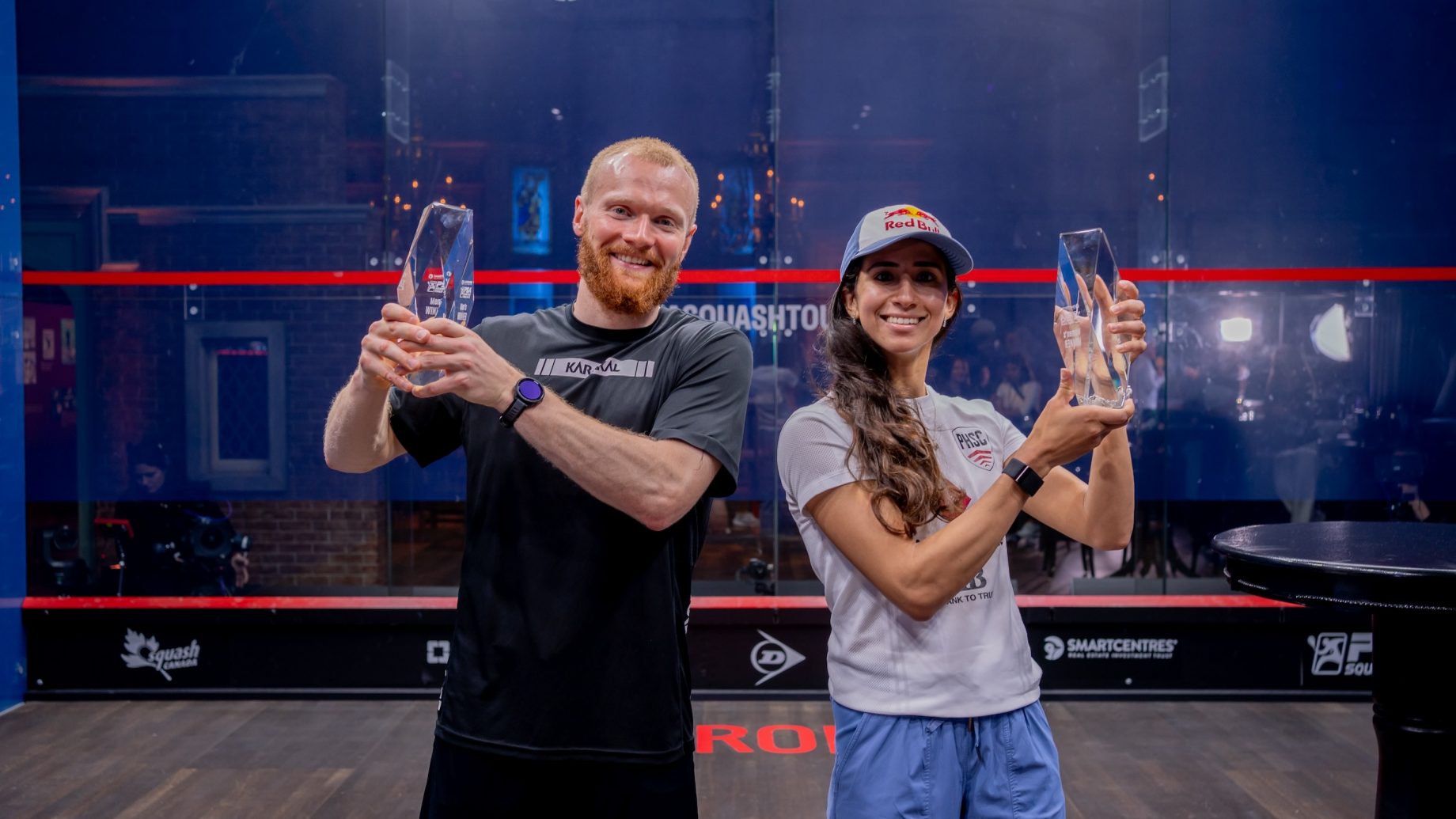 Joel Makin (left) and Nouran Gohar (right) with the 2024-25 PSA Squash Tour Finals trophies.